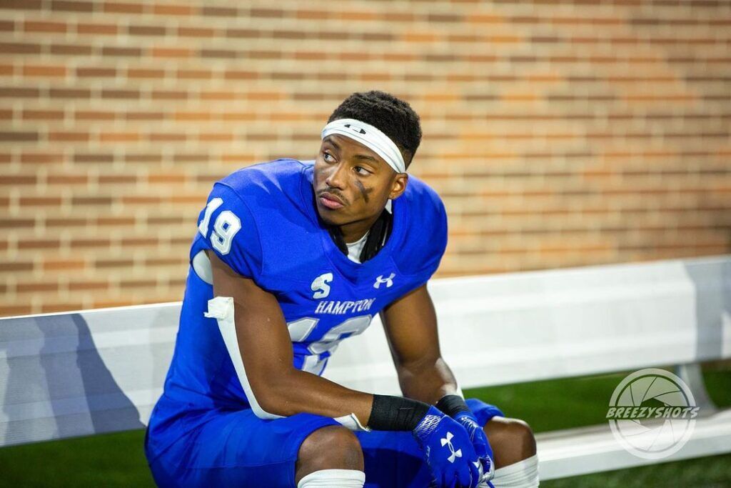 Byron Perkins sits on a bench