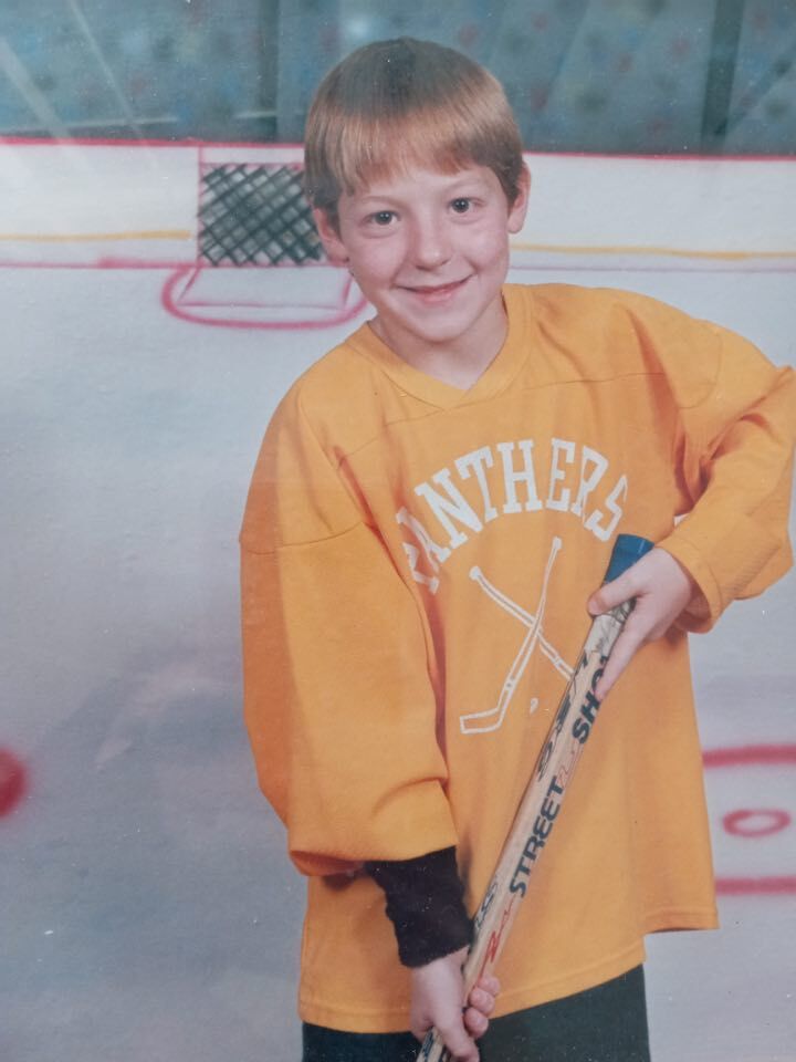 Youth hockey player poses for a photo