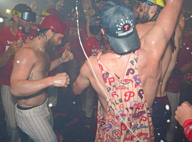 Baseball players celebrate a win in locker room
