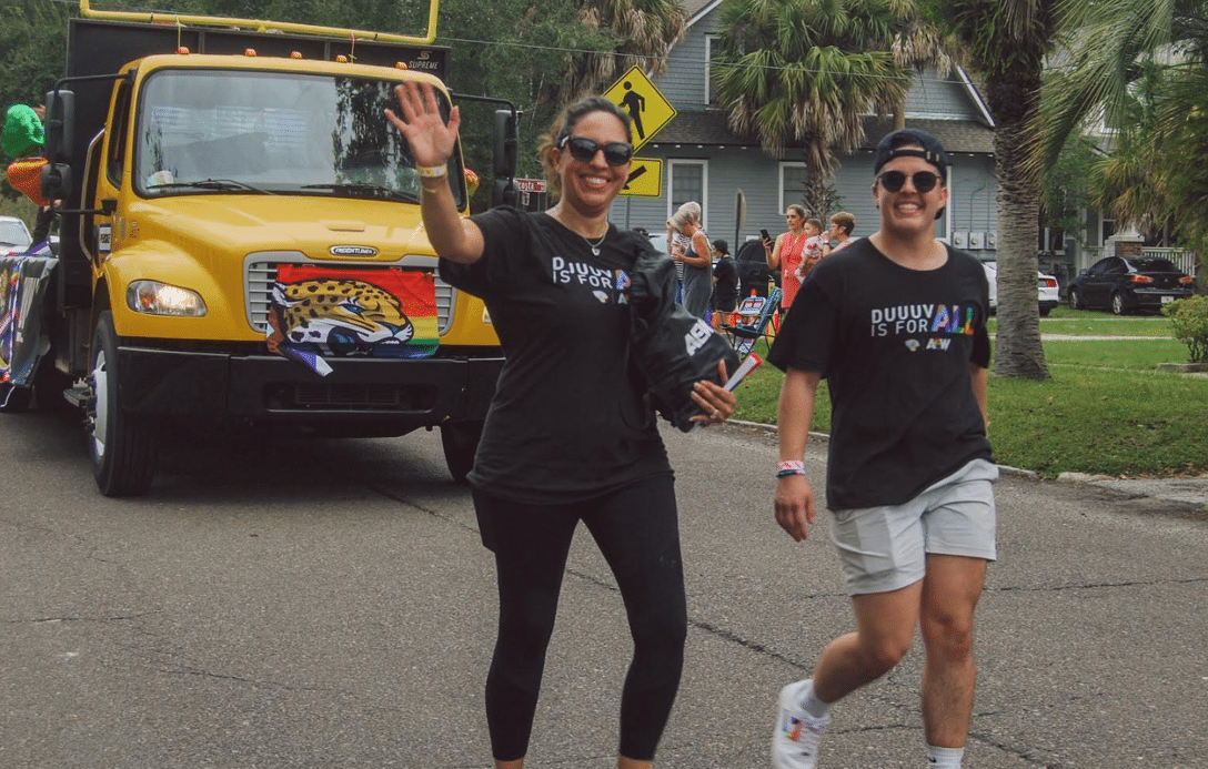 Two people walking in a Pride Parade